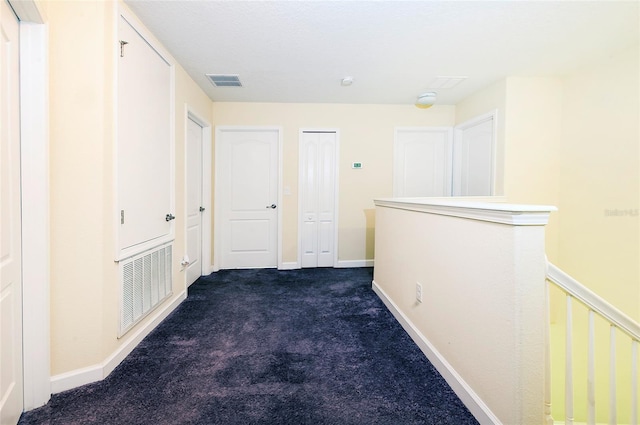 1748 Thetford Cir, Orlando, FL 32824 - hallway with dark colored carpet and baseboards