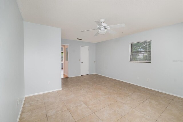 450 S Buena Vista Ave, Orlando, FL 32835 - unfurnished room featuring a ceiling fan, light tile patterned floors, and baseboards