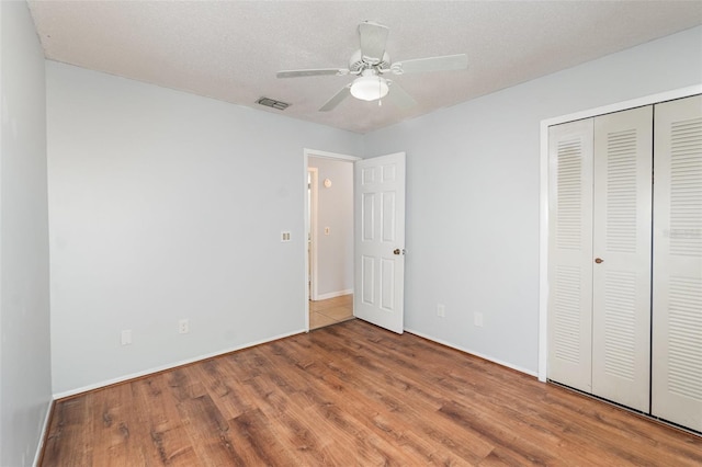 450 S Buena Vista Ave, Orlando, FL 32835 - unfurnished bedroom featuring wood finished floors, a closet, baseboards, and a ceiling fan