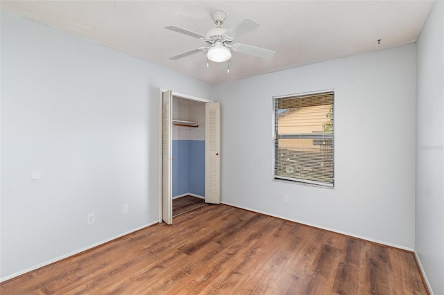 450 S Buena Vista Ave, Orlando, FL 32835 - unfurnished bedroom with wood finished floors, a closet, baseboards, and ceiling fan
