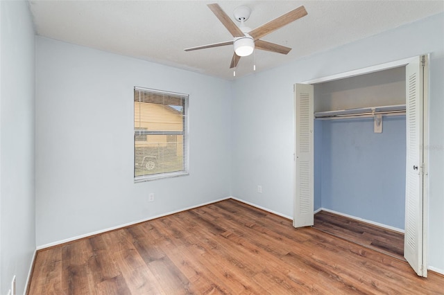 450 S Buena Vista Ave, Orlando, FL 32835 - unfurnished bedroom with wood finished floors, a closet, a ceiling fan, and baseboards