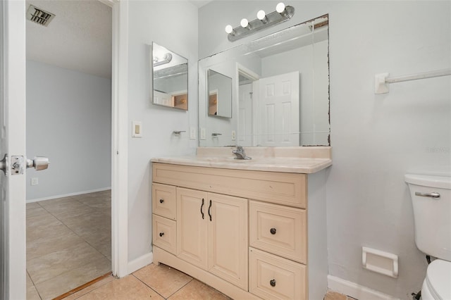 450 S Buena Vista Ave, Orlando, FL 32835 - bathroom featuring toilet, vanity, tile patterned flooring, and baseboards