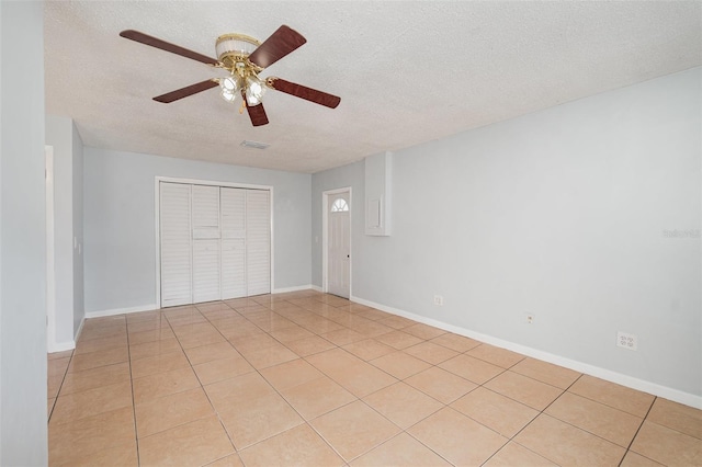 450 S Buena Vista Ave, Orlando, FL 32835 - unfurnished room featuring a textured ceiling, ceiling fan, light tile patterned floors, and baseboards
