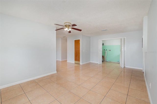 450 S Buena Vista Ave, Orlando, FL 32835 - unfurnished room with a ceiling fan, light tile patterned flooring, a textured ceiling, and baseboards