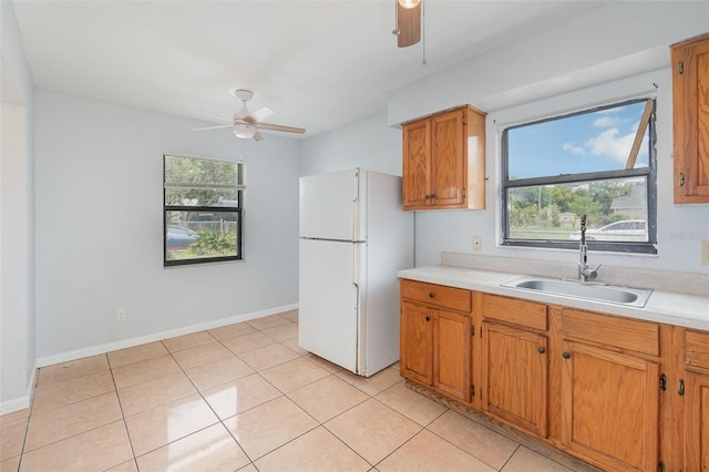 450 S Buena Vista Ave, Orlando, FL 32835 - kitchen with a sink, freestanding refrigerator, ceiling fan, and light countertops