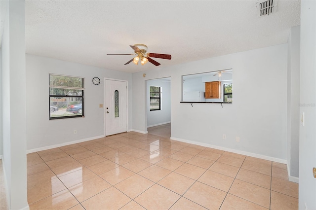 450 S Buena Vista Ave, Orlando, FL 32835 - foyer with ceiling fan, plenty of natural light, light tile patterned flooring, and baseboards