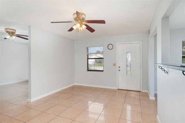 450 S Buena Vista Ave, Orlando, FL 32835 - entrance foyer featuring a ceiling fan, light tile patterned floors, a textured ceiling, and baseboards