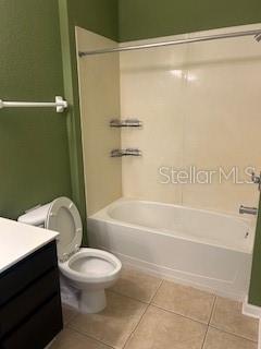 8775 Sartori St Unit 307, Orlando, FL 32829 - bathroom featuring vanity, tile patterned floors, toilet, and shower / bath combination