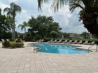 8775 Sartori St Unit 307, Orlando, FL 32829 - community pool with a patio area
