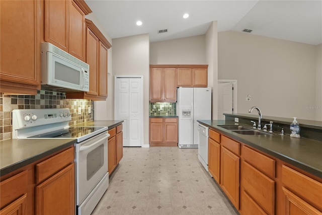 1227 Juniper Hammock St, Winter Garden, FL 34787 - kitchen with white appliances, a sink, dark countertops, light flooring, and lofted ceiling