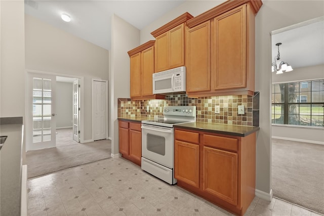1227 Juniper Hammock St, Winter Garden, FL 34787 - kitchen featuring white appliances, light carpet, dark countertops, and plenty of natural light