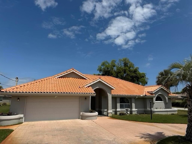 2 Bickshire Ln, Palm Coast, FL 32137 - mediterranean / spanish-style home featuring driveway, a garage, and stucco siding