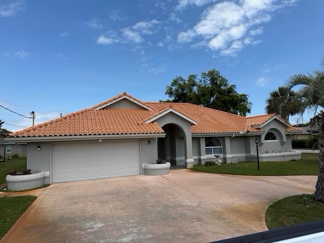 2 Bickshire Ln, Palm Coast, FL 32137 - view of front facade with concrete driveway, an attached garage, a tile roof, and stucco siding
