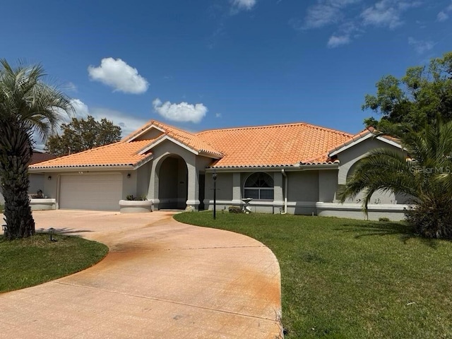2 Bickshire Ln, Palm Coast, FL 32137 - mediterranean / spanish house featuring stucco siding, a garage, driveway, and a tiled roof