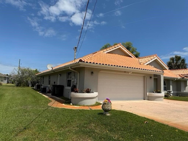 2 Bickshire Ln, Palm Coast, FL 32137 - view of front of house featuring stucco siding, an attached garage, driveway, a tile roof, and a front lawn