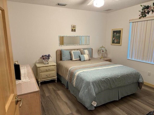 2 Bickshire Ln, Palm Coast, FL 32137 - bedroom with dark wood-style floors, a textured ceiling, and a ceiling fan