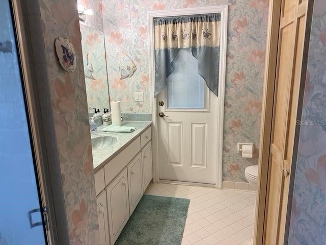 2 Bickshire Ln, Palm Coast, FL 32137 - bathroom featuring wallpapered walls, tile patterned flooring, toilet, vanity, and baseboards