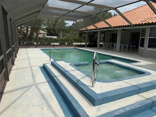 2 Bickshire Ln, Palm Coast, FL 32137 - view of pool featuring ceiling fan, a pool with connected hot tub, a patio, and glass enclosure