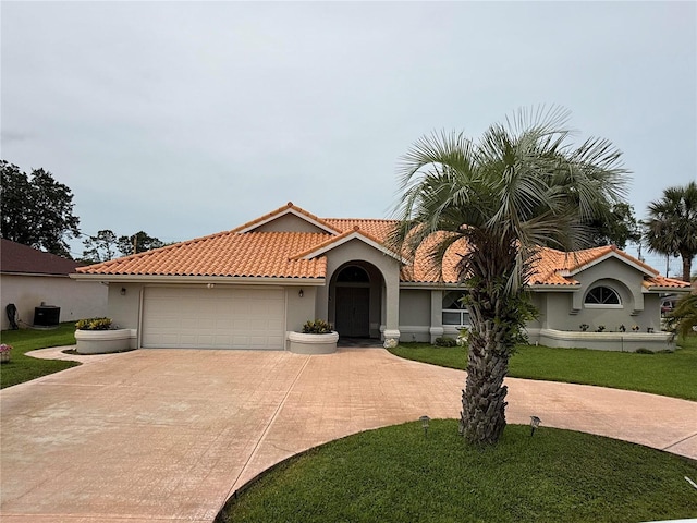 2 Bickshire Ln, Palm Coast, FL 32137 - mediterranean / spanish house with driveway, an attached garage, stucco siding, and a tile roof