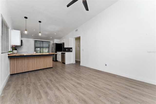 415 S Lancelot Ave, Orlando, FL 32835 - kitchen with appliances with stainless steel finishes, open floor plan, light wood-type flooring, ceiling fan, and lofted ceiling