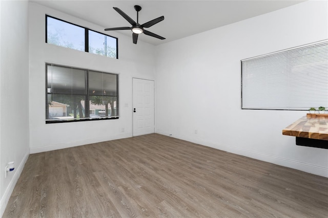 415 S Lancelot Ave, Orlando, FL 32835 - empty room featuring wood finished floors, ceiling fan, baseboards, and a high ceiling