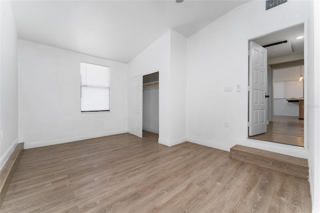 415 S Lancelot Ave, Orlando, FL 32835 - unfurnished bedroom featuring light wood-style flooring, lofted ceiling, baseboards, and a closet