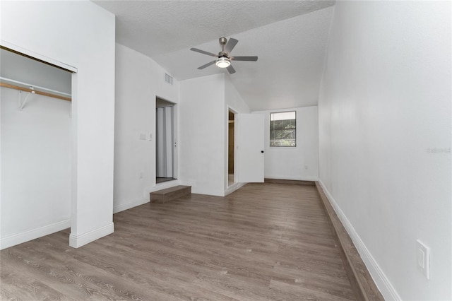 415 S Lancelot Ave, Orlando, FL 32835 - unfurnished bedroom with lofted ceiling, wood finished floors, baseboards, a textured ceiling, and ceiling fan