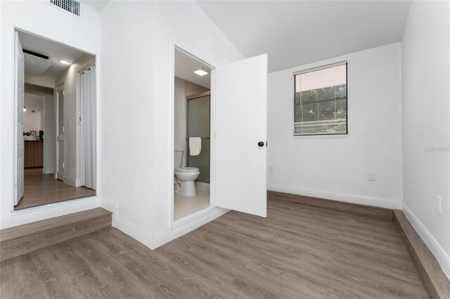 415 S Lancelot Ave, Orlando, FL 32835 - unfurnished bedroom with baseboards, wood finished floors, and ensuite bath