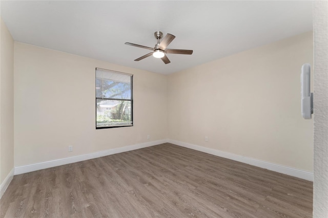 415 S Lancelot Ave, Orlando, FL 32835 - spare room with wood finished floors, ceiling fan, and baseboards
