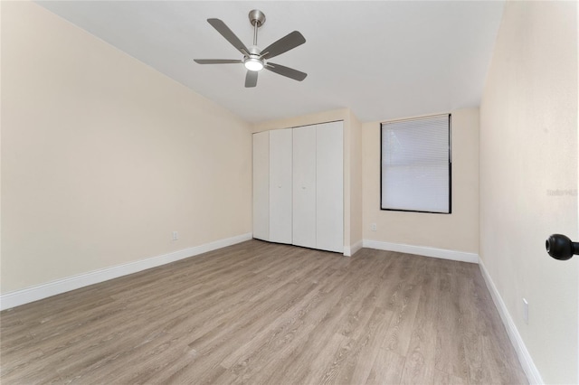 415 S Lancelot Ave, Orlando, FL 32835 - unfurnished bedroom featuring wood finished floors, baseboards, a closet, and a ceiling fan