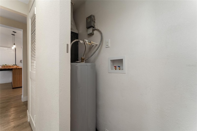 415 S Lancelot Ave, Orlando, FL 32835 - washroom with water heater, wood finished floors, baseboards, and hookup for a washing machine