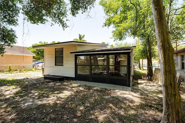 415 S Lancelot Ave, Orlando, FL 32835 - rear view of property with a sunroom