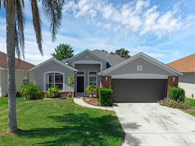 468 Jaybee Ave, Davenport, FL 33897 - ranch-style house featuring an attached garage, concrete driveway, brick siding, a front lawn, and stucco siding