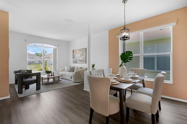 468 Jaybee Ave, Davenport, FL 33897 - dining space with dark wood-style floors, baseboards, and a chandelier