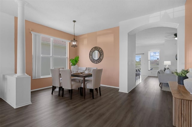 468 Jaybee Ave, Davenport, FL 33897 - dining space featuring dark wood-type flooring, ornate columns, ceiling fan, and arched walkways