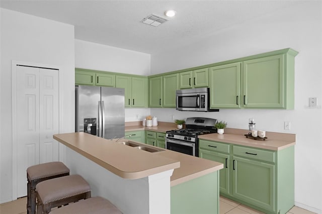 468 Jaybee Ave, Davenport, FL 33897 - kitchen with appliances with stainless steel finishes, a sink, green cabinets, and a textured ceiling