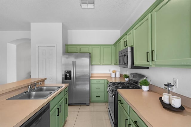 468 Jaybee Ave, Davenport, FL 33897 - kitchen with stainless steel appliances, a sink, green cabinets, light countertops, and a textured ceiling