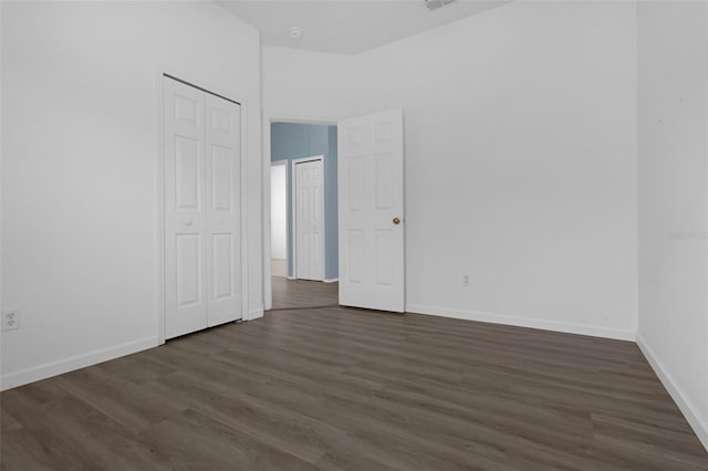 468 Jaybee Ave, Davenport, FL 33897 - unfurnished bedroom featuring dark wood-style flooring and baseboards