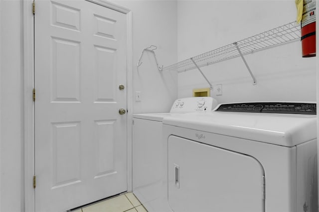 468 Jaybee Ave, Davenport, FL 33897 - laundry area with washer and clothes dryer and light tile patterned flooring