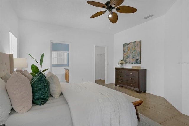 468 Jaybee Ave, Davenport, FL 33897 - bedroom featuring a walk in closet, light tile patterned flooring, a ceiling fan, ensuite bath, and a closet