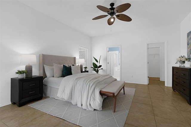 468 Jaybee Ave, Davenport, FL 33897 - bedroom featuring light tile patterned floors, a spacious closet, ensuite bath, and baseboards