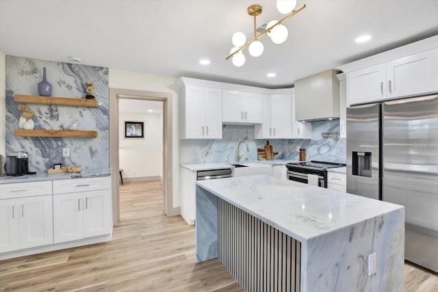 203 Driftwood Dr W, Palm Harbor, FL 34683 - kitchen with stainless steel appliances, a sink, light wood-style floors, white cabinetry, and recessed lighting