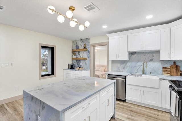 203 Driftwood Dr W, Palm Harbor, FL 34683 - kitchen with stainless steel dishwasher, open shelves, tasteful backsplash, a sink, and white cabinets