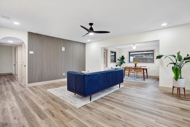 203 Driftwood Dr W, Palm Harbor, FL 34683 - living area featuring arched walkways, light wood-style floors, ceiling fan, baseboards, and recessed lighting