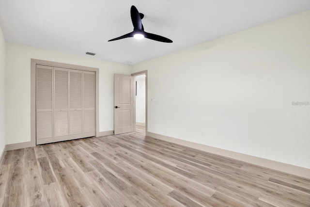 203 Driftwood Dr W, Palm Harbor, FL 34683 - unfurnished bedroom featuring light wood finished floors, a closet, a ceiling fan, and baseboards