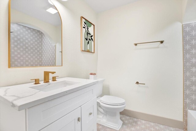 203 Driftwood Dr W, Palm Harbor, FL 34683 - full bathroom with vanity, toilet, a tub to relax in, and tile patterned floors