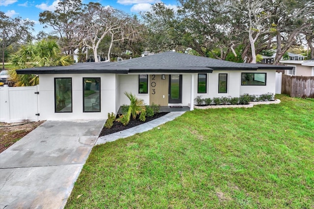 203 Driftwood Dr W, Palm Harbor, FL 34683 - view of front of house with a shingled roof, driveway, a gate, and stucco siding