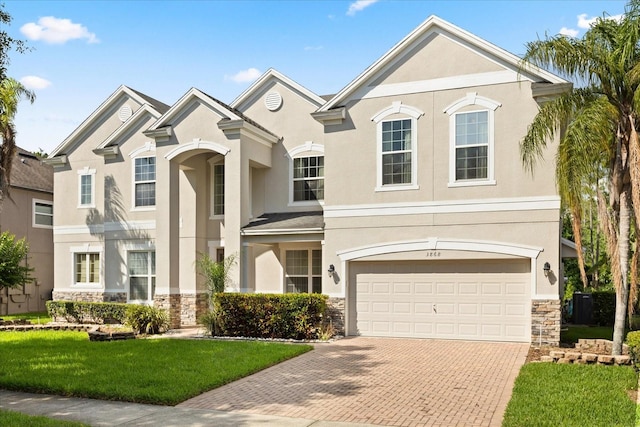 3868 Whitewood Ct, Oviedo, FL 32766 - view of front of house featuring stone siding, decorative driveway, and stucco siding