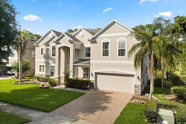 3868 Whitewood Ct, Oviedo, FL 32766 - view of front of house featuring stone siding, decorative driveway, stucco siding, a garage, and a front yard