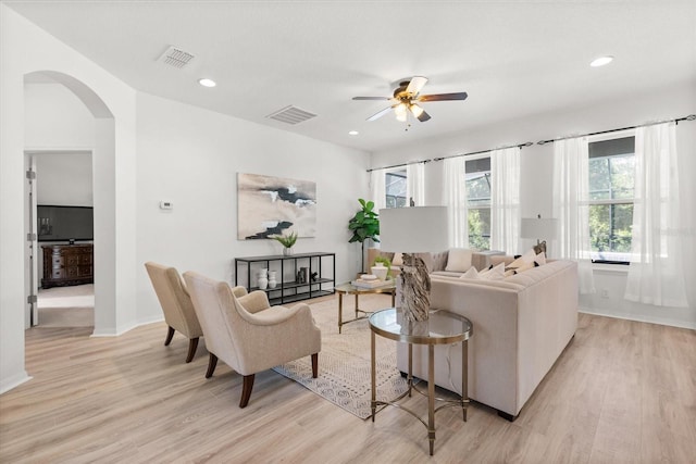 3868 Whitewood Ct, Oviedo, FL 32766 - living area featuring arched walkways, light wood-style flooring, a ceiling fan, recessed lighting, and baseboards